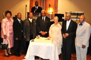 ABC founding members pose by the 25th Anniversary Cake