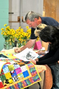 Church goers at Asbury UMC sign quilts for Japan